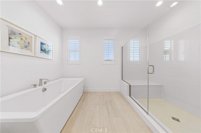 112 Sentosa, Irvine, CA 92618 - bathroom featuring a freestanding tub, recessed lighting, a stall shower, and baseboards