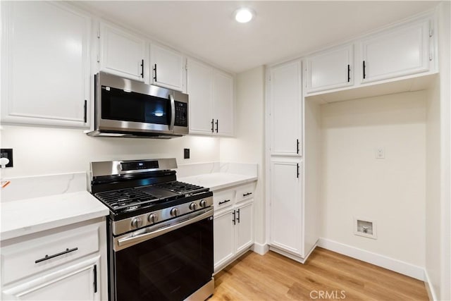 44505 Galicia Dr, Hemet, CA 92544 - kitchen with stainless steel appliances, light wood finished floors, white cabinetry, and recessed lighting