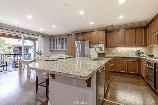 1123 Klose Ln, Fullerton, CA 92833 - kitchen with appliances with stainless steel finishes, a sink, a breakfast bar area, dark wood-style flooring, and recessed lighting