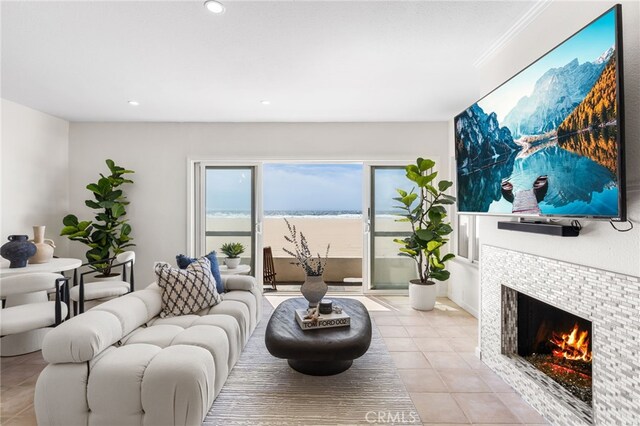 3012 W Oceanfront, Newport Beach, CA 92663 - living room with light tile patterned floors, a tile fireplace, and recessed lighting