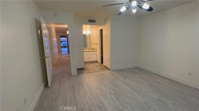 2605 Auburn Ct, Bakersfield, CA 93306 - unfurnished bedroom featuring light wood-type flooring, baseboards, and connected bathroom