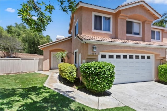 2285 Arabian Way, Corona, CA 92879 - mediterranean / spanish house featuring a tile roof, stucco siding, an attached garage, and concrete driveway