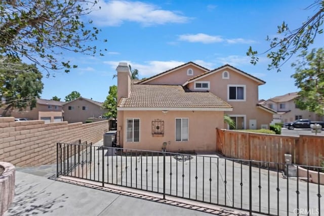 2285 Arabian Way, Corona, CA 92879 - rear view of house with stucco siding, a chimney, a tiled roof, and a residential view