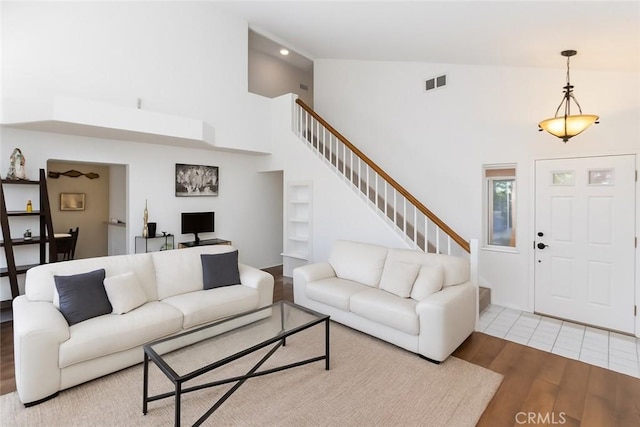 2285 Arabian Way, Corona, CA 92879 - living area featuring wood finished floors, high vaulted ceiling, and stairs
