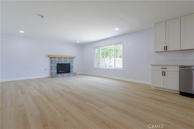 25411 Cottage Ave, Loma Linda, CA 92354 - unfurnished living room with light wood finished floors, a tile fireplace, and recessed lighting