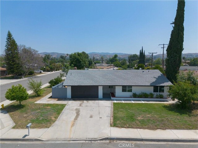25411 Cottage Ave, Loma Linda, CA 92354 - ranch-style house featuring concrete driveway, a mountain view, a front yard, and a shingled roof