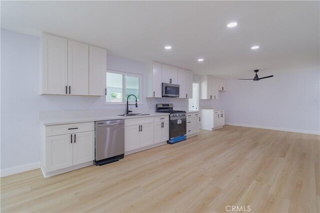 25411 Cottage Ave, Loma Linda, CA 92354 - kitchen with stainless steel appliances, light wood-style floors, light countertops, recessed lighting, and ceiling fan