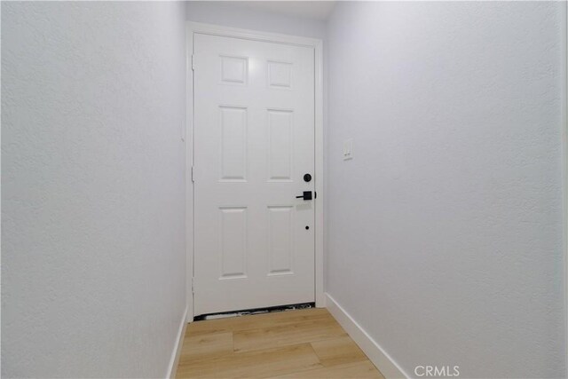 25411 Cottage Ave, Loma Linda, CA 92354 - doorway featuring light wood-type flooring and baseboards
