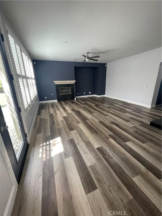 2431 Elizabeth Ct, Upland, CA 91784 - unfurnished living room with ceiling fan, a glass covered fireplace, and wood finished floors