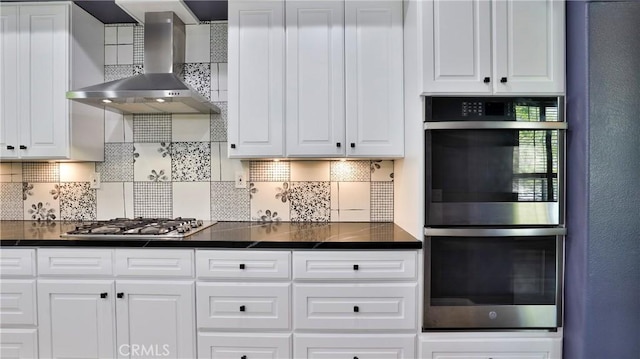 2431 Elizabeth Ct, Upland, CA 91784 - kitchen with stainless steel appliances, wall chimney range hood, dark countertops, and white cabinets