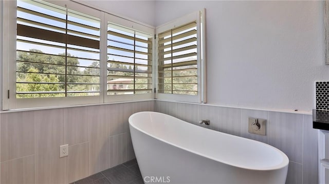 2431 Elizabeth Ct, Upland, CA 91784 - full bathroom featuring a freestanding bath, a wainscoted wall, and tile patterned flooring