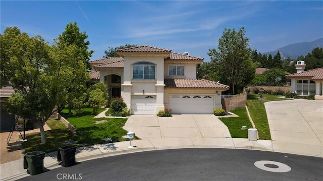 2431 Elizabeth Ct, Upland, CA 91784 - mediterranean / spanish-style house with stucco siding, a tile roof, driveway, and a front yard