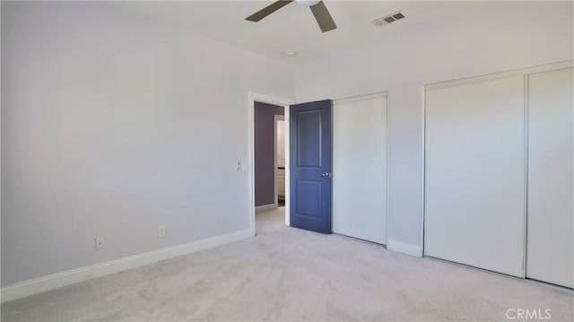 2431 Elizabeth Ct, Upland, CA 91784 - unfurnished bedroom featuring two closets, light carpet, and a ceiling fan