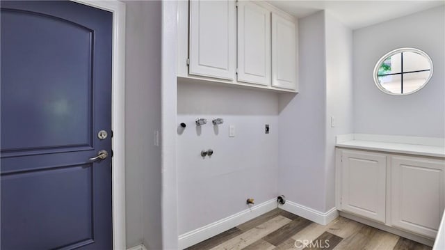 2431 Elizabeth Ct, Upland, CA 91784 - laundry area with cabinet space, light wood-style floors, gas dryer hookup, hookup for an electric dryer, and washer hookup