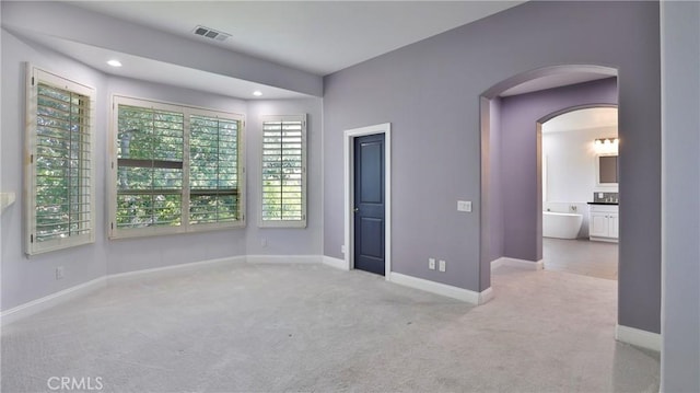 2431 Elizabeth Ct, Upland, CA 91784 - carpeted empty room featuring arched walkways and recessed lighting