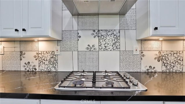 2431 Elizabeth Ct, Upland, CA 91784 - kitchen featuring stainless steel gas stovetop, wall chimney range hood, tasteful backsplash, and dark countertops
