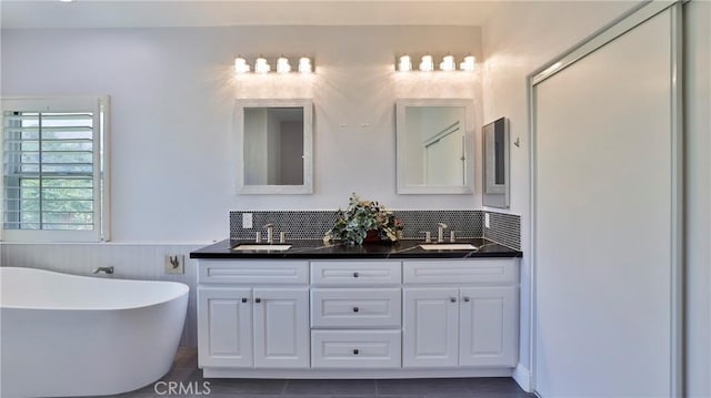 2431 Elizabeth Ct, Upland, CA 91784 - bathroom with double vanity, a freestanding bath, and wainscoting
