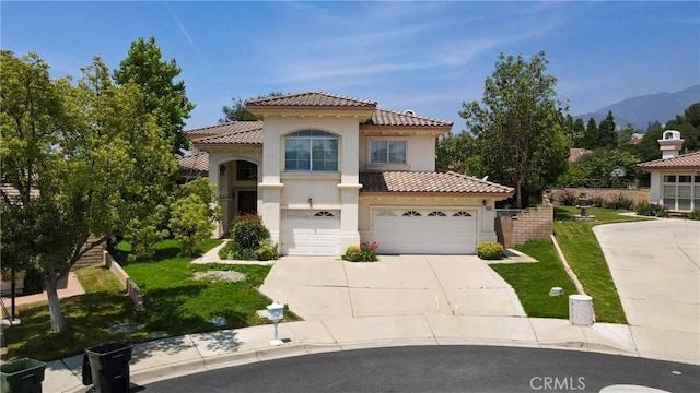 2431 Elizabeth Ct, Upland, CA 91784 - mediterranean / spanish-style house with stucco siding, a tiled roof, concrete driveway, and a front lawn