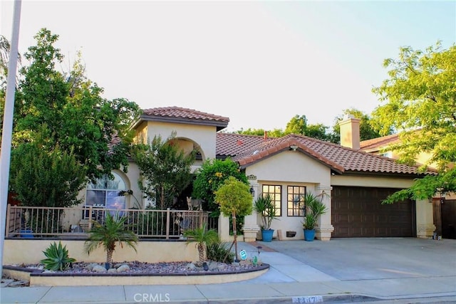 1447 Genoa Ln, San Jacinto, CA 92583 - mediterranean / spanish home with an attached garage, stucco siding, driveway, a tile roof, and a chimney