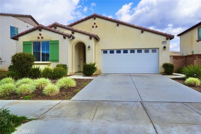 3042 Eveningcloud St, Hemet, CA 92543 - mediterranean / spanish house featuring driveway, an attached garage, a tiled roof, and stucco siding