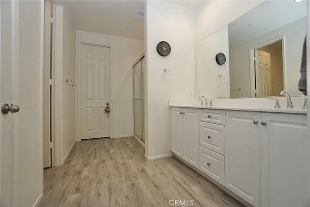 3042 Eveningcloud St, Hemet, CA 92543 - full bath featuring double vanity, wood finished floors, baseboards, and a shower with door