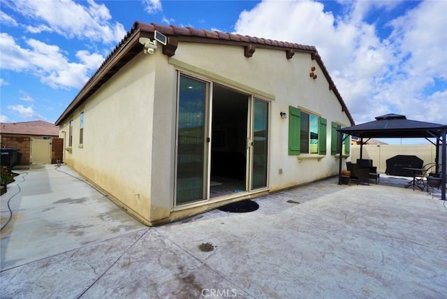 3042 Eveningcloud St, Hemet, CA 92543 - rear view of property with a patio area, a gazebo, stucco siding, and a tiled roof