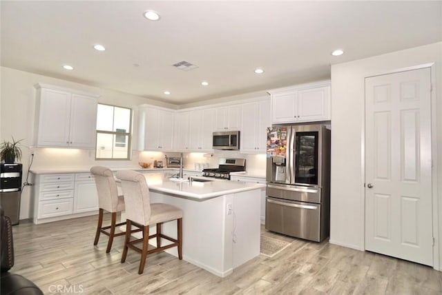 3042 Eveningcloud St, Hemet, CA 92543 - kitchen with appliances with stainless steel finishes, light wood finished floors, white cabinetry, light countertops, and recessed lighting
