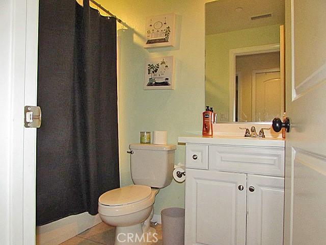 3981 E Emory Ln Unit 6, Ontario, CA 91761 - bathroom featuring vanity, toilet, tile patterned flooring, and a shower with curtain