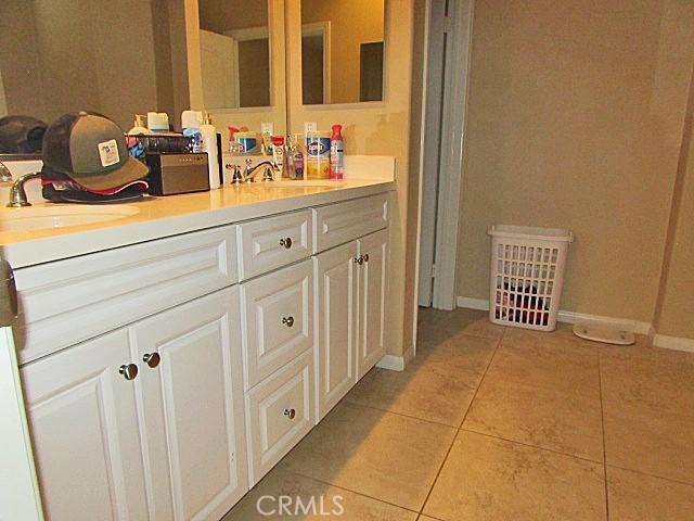 3981 E Emory Ln Unit 6, Ontario, CA 91761 - full bathroom featuring tile patterned flooring, double vanity, and baseboards