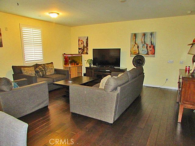 3981 E Emory Ln Unit 6, Ontario, CA 91761 - living room with dark wood-style flooring and baseboards