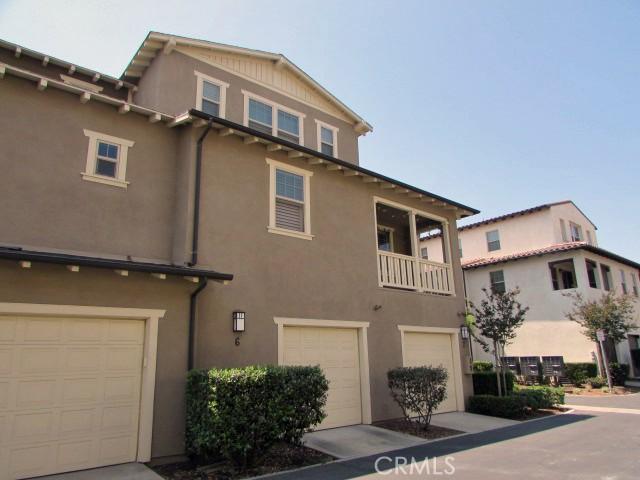 3981 E Emory Ln Unit 6, Ontario, CA 91761 - view of front of home with an attached garage, stucco siding, and a balcony