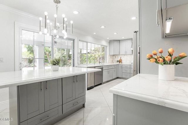 8857 Bluffdale Dr, Sun Valley, CA 91352 - kitchen featuring gray cabinets, dishwasher, ornamental molding, tasteful backsplash, and light stone countertops