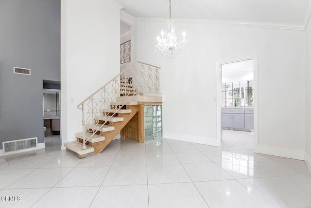 8857 Bluffdale Dr, Sun Valley, CA 91352 - staircase featuring a chandelier, crown molding, a towering ceiling, baseboards, and tile patterned flooring