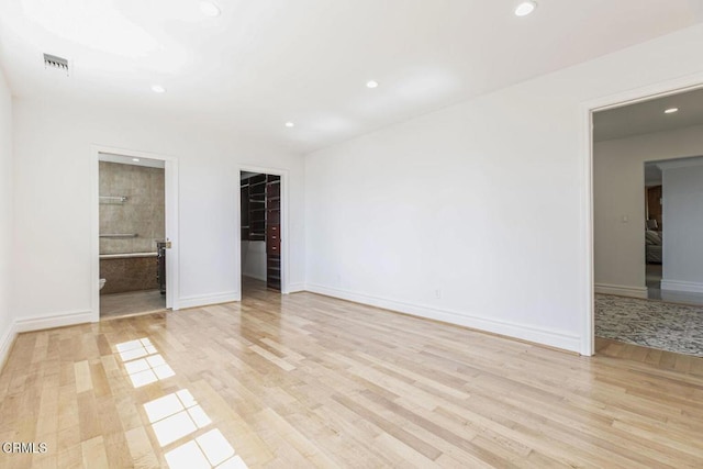 8857 Bluffdale Dr, Sun Valley, CA 91352 - unfurnished bedroom featuring light wood-style flooring, recessed lighting, a walk in closet, baseboards, and ensuite bathroom