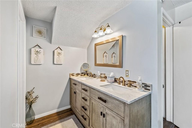 5644 Wadsworth Ave, Highland, CA 92346 - bathroom with double vanity, a textured ceiling, wood finished floors, and lofted ceiling