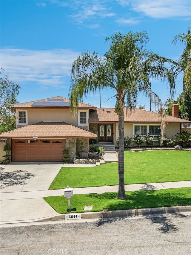 5644 Wadsworth Ave, Highland, CA 92346 - tri-level home featuring roof mounted solar panels, stucco siding, concrete driveway, and a front lawn