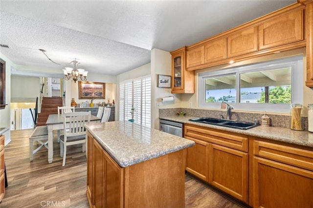 5644 Wadsworth Ave, Highland, CA 92346 - kitchen with a chandelier, stainless steel dishwasher, wood finished floors, healthy amount of natural light, and a textured ceiling