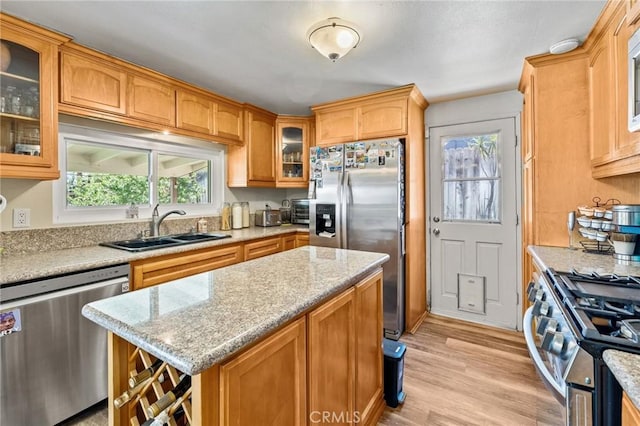 5644 Wadsworth Ave, Highland, CA 92346 - kitchen with stainless steel appliances, healthy amount of natural light, glass insert cabinets, and light wood-style flooring