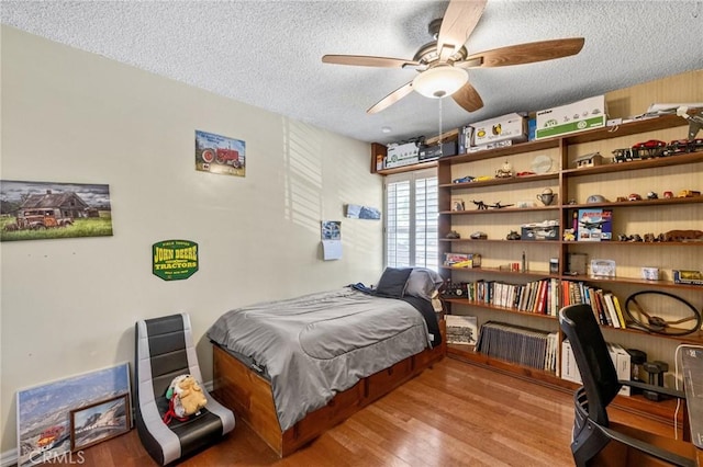 5644 Wadsworth Ave, Highland, CA 92346 - bedroom with a textured ceiling, wood finished floors, and an office area