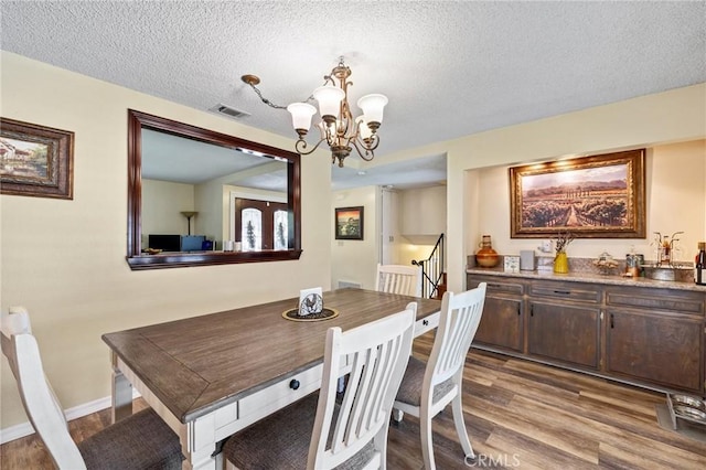 5644 Wadsworth Ave, Highland, CA 92346 - dining space with a chandelier, wood finished floors, and a textured ceiling