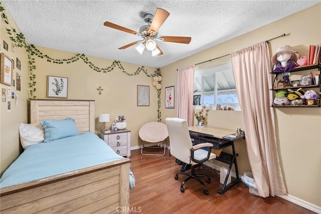 5644 Wadsworth Ave, Highland, CA 92346 - bedroom featuring wood finished floors, a textured ceiling, a desk, and a ceiling fan