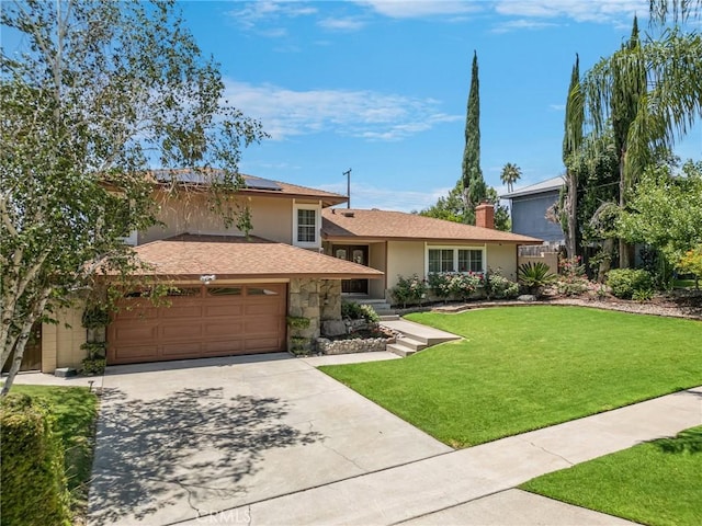 5644 Wadsworth Ave, Highland, CA 92346 - split level home featuring a front lawn, roof mounted solar panels, concrete driveway, a garage, and stucco siding