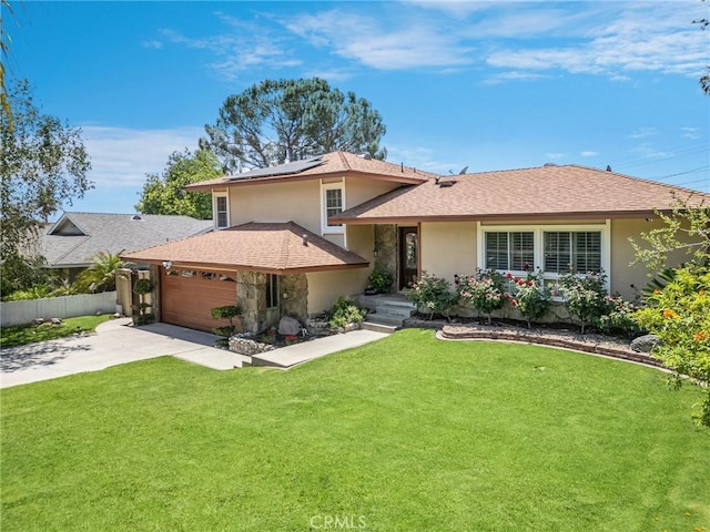 5644 Wadsworth Ave, Highland, CA 92346 - split level home featuring solar panels, driveway, an attached garage, stucco siding, and a shingled roof