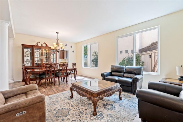 24101 Crowned Partridge Ln, Murrieta, CA 92562 - living room with a chandelier, light wood finished floors, and decorative columns