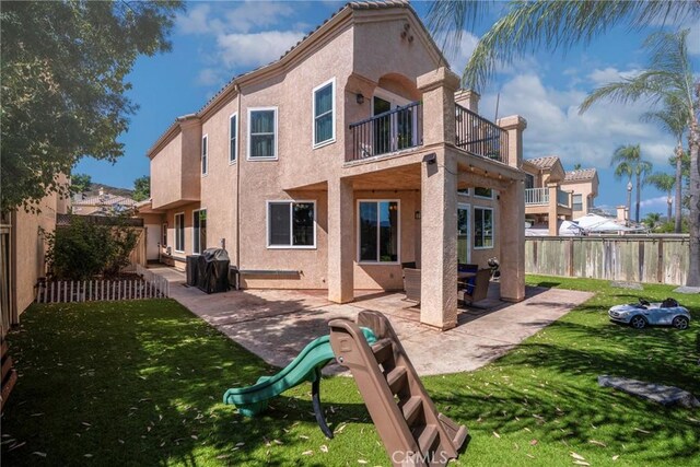 24101 Crowned Partridge Ln, Murrieta, CA 92562 - back of property featuring a balcony, stucco siding, and a patio