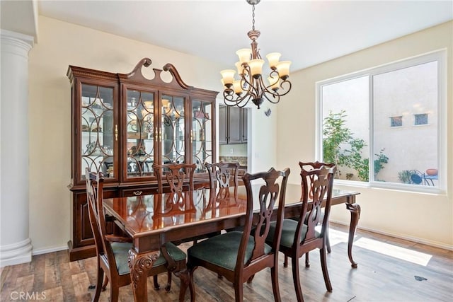 24101 Crowned Partridge Ln, Murrieta, CA 92562 - dining space with a chandelier, wood finished floors, and decorative columns