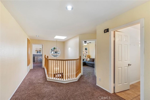 24101 Crowned Partridge Ln, Murrieta, CA 92562 - hallway featuring light colored carpet, recessed lighting, and a skylight