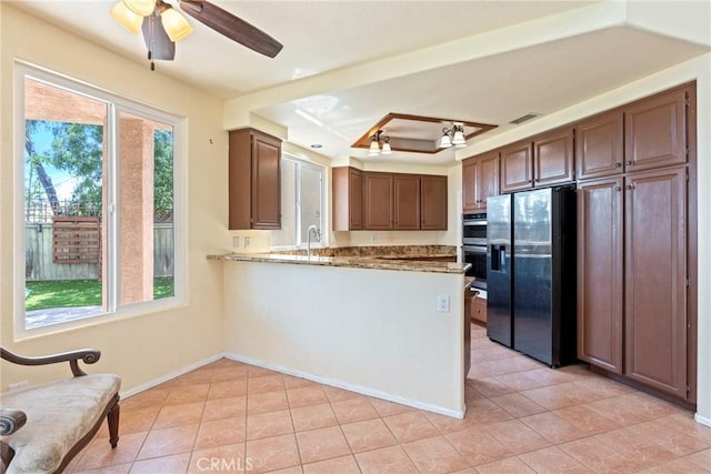 24101 Crowned Partridge Ln, Murrieta, CA 92562 - kitchen featuring refrigerator with ice dispenser, double oven, light tile patterned floors, and a peninsula