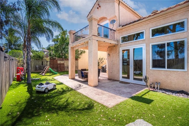 24101 Crowned Partridge Ln, Murrieta, CA 92562 - rear view of house featuring a balcony, french doors, stucco siding, a fenced backyard, and a patio