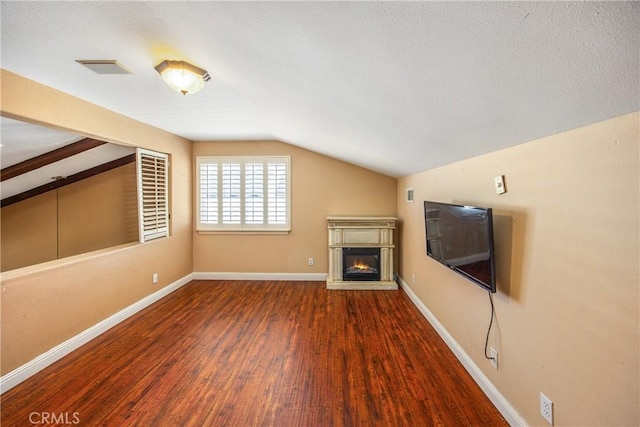 27470 Lakeview Dr, Helendale, CA 92342 - unfurnished living room featuring lofted ceiling, wood finished floors, a glass covered fireplace, and baseboards